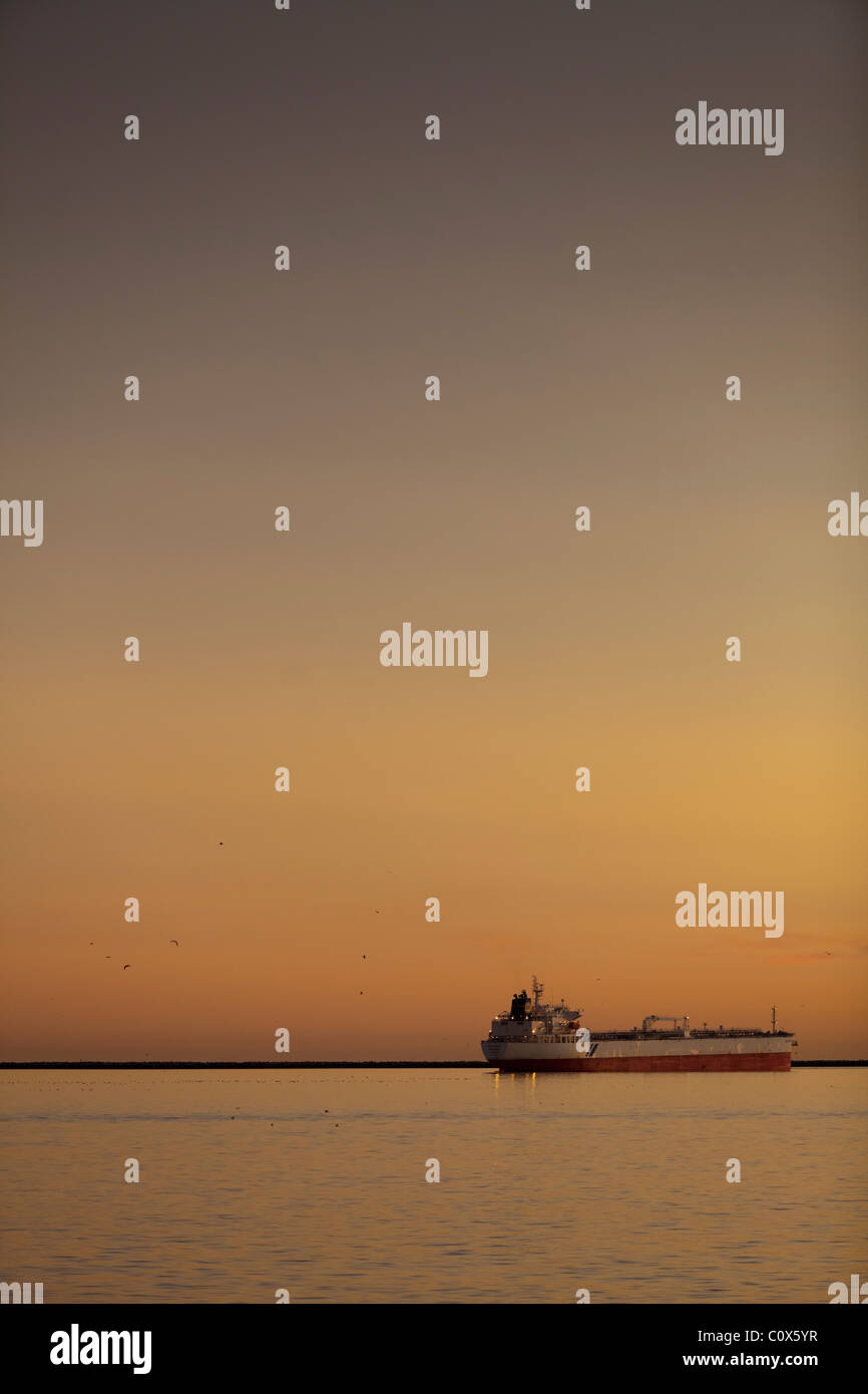 Oil tanker ship in ocean outside the Port of Los Angeles, sunset. Stock Photo