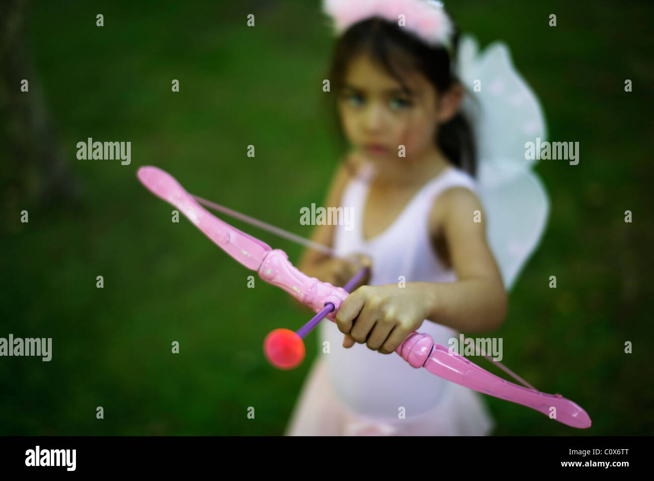 Five year old girl girl in fairy costume with pink bow and arrow Stock Photo