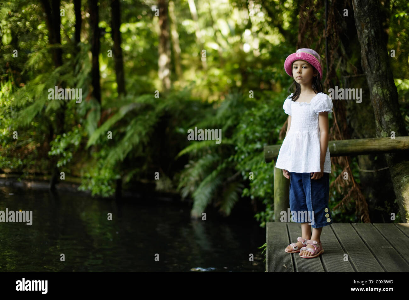Girl stands beside lake Stock Photo