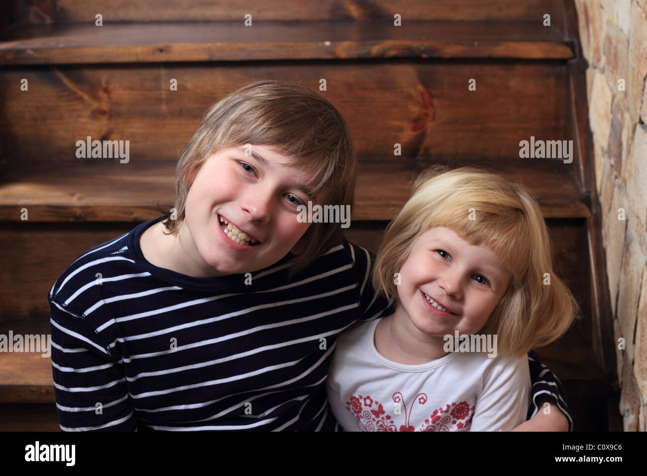 Brother and sister sitting on the stairs Stock Photo - Alamy