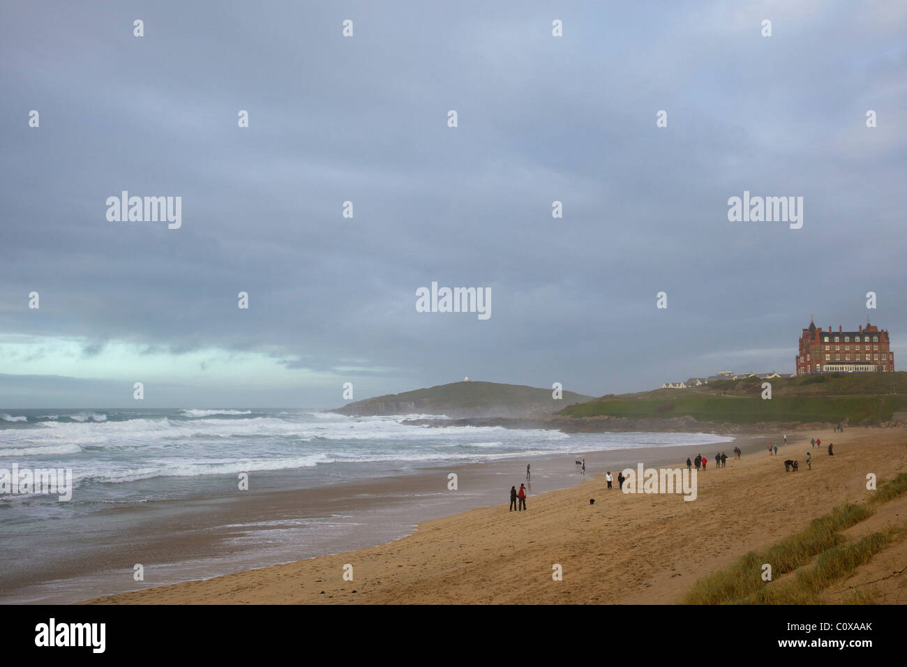 Walkers enjoy the winter surf, Fistral Beach,  Newquay, Cornwall, South West England, UK, United Kingdom, GB, Great Britain, Bri Stock Photo