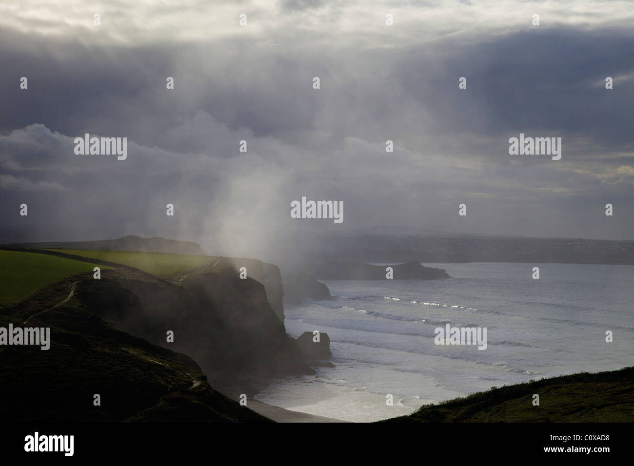 Sun and rain from winter storm, Watergate Bay, Newquay, Cornwall, South West England, UK, United Kingdom, GB, Great Britain Stock Photo