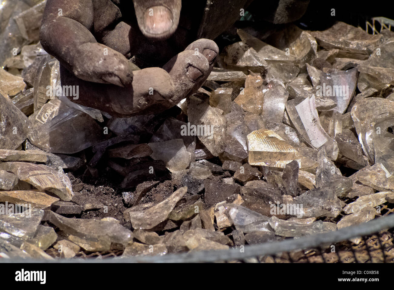 A Nicaraguan man recollects glass cullets for recycling in the garbage dump La Chureca, Managua, Nicaragua. Stock Photo