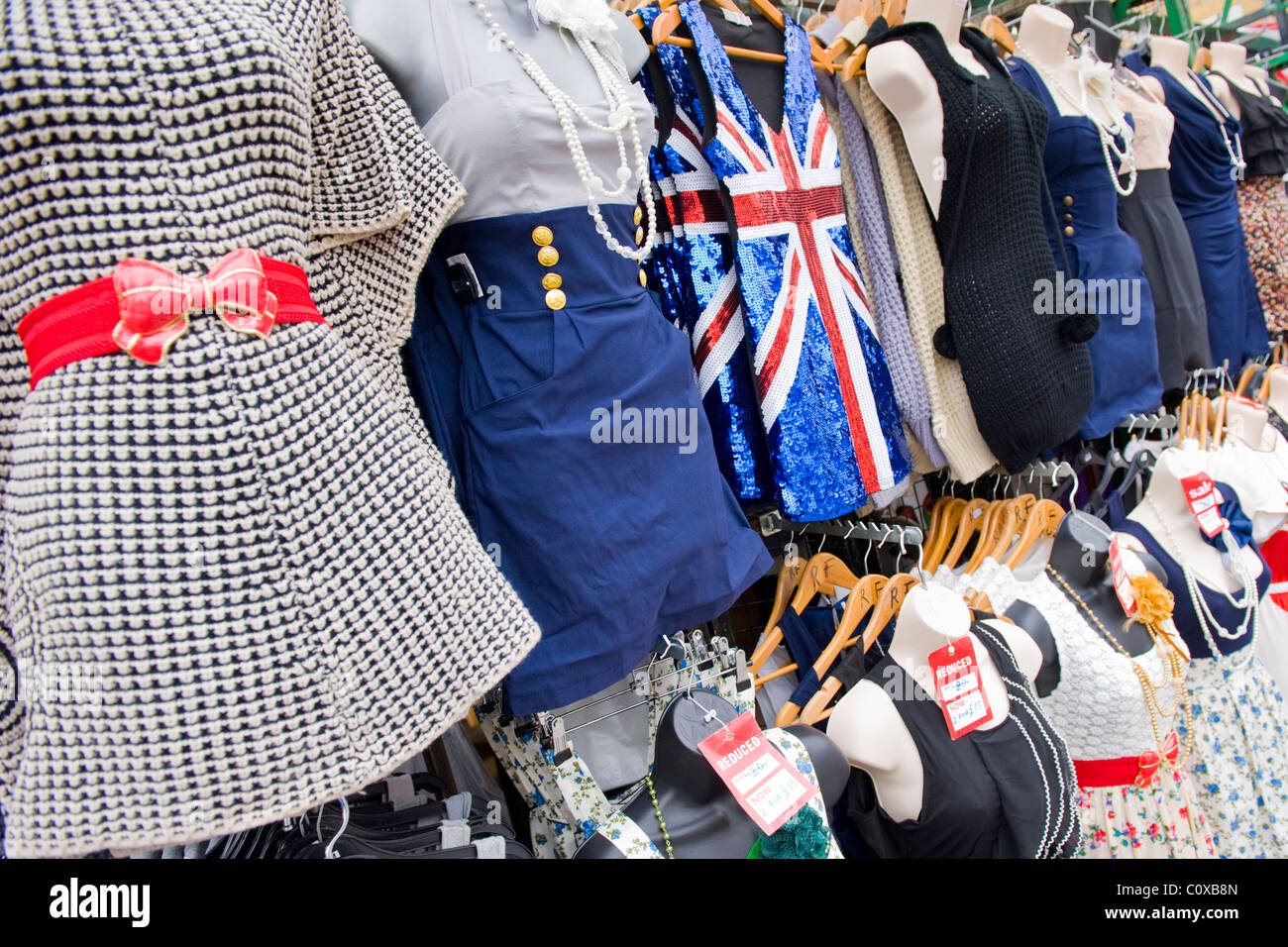 Camden Town or Lock or Horses Market , London , stall with retro miniskirts & dresses & union jack dress Stock Photo