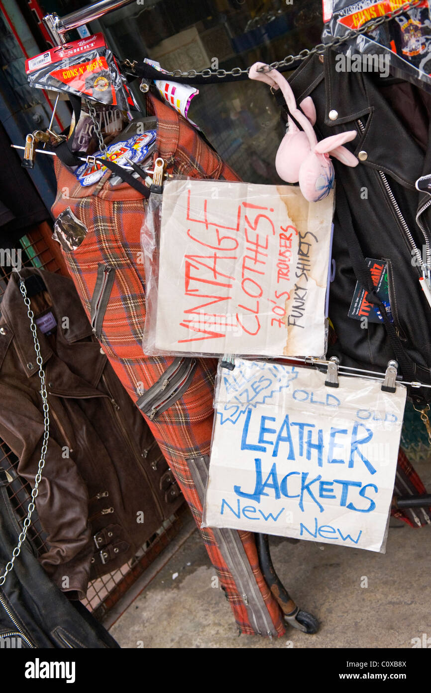 Camden Town or Lock or Horses Market , London , vintage old used clothes stall display with tartan trousers & leather jackets Stock Photo
