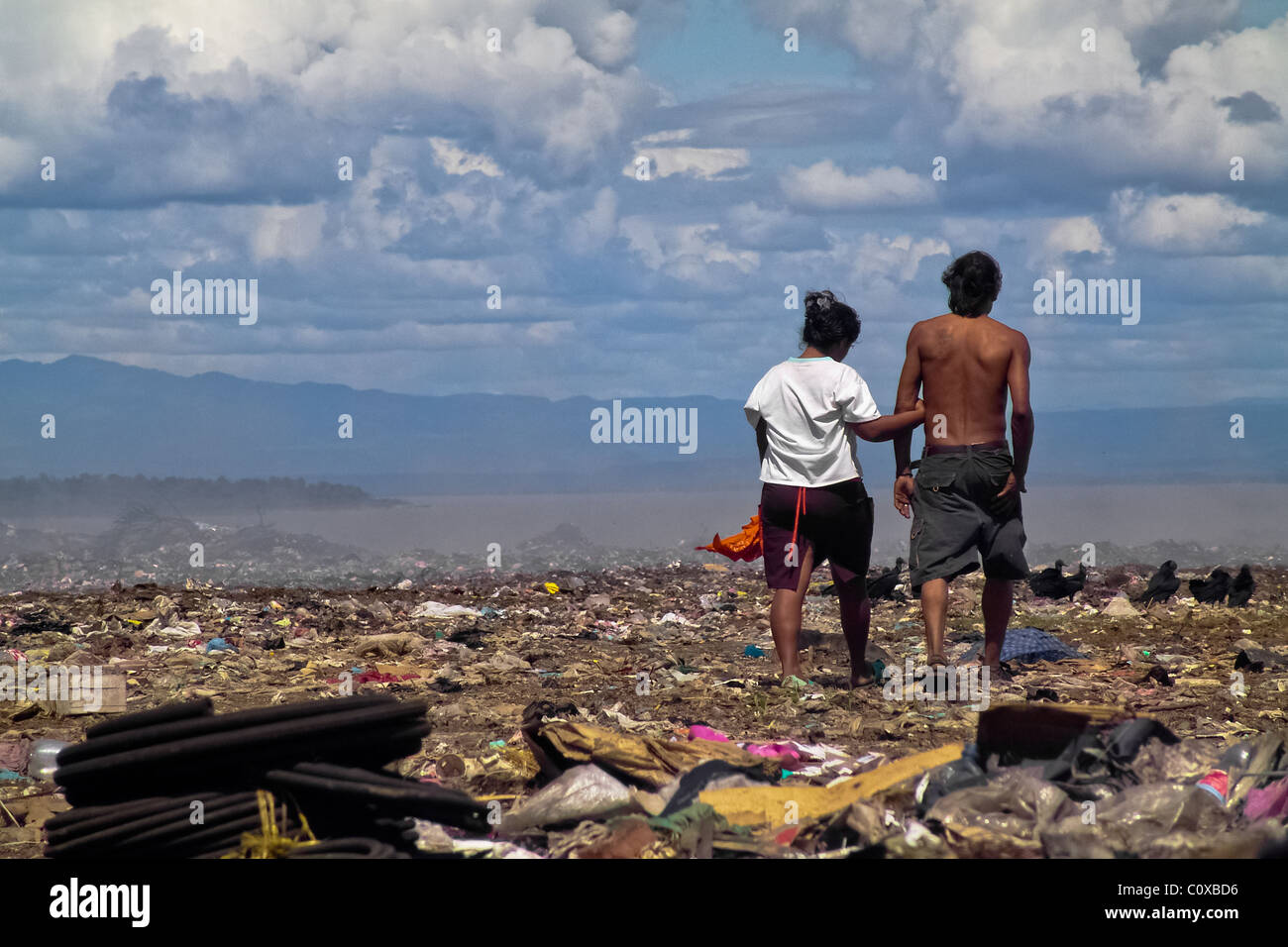 A Nicaraguan couple of garbage recollectors walks in the garbage dump La Chureca, Managua, Nicaragua. Stock Photo