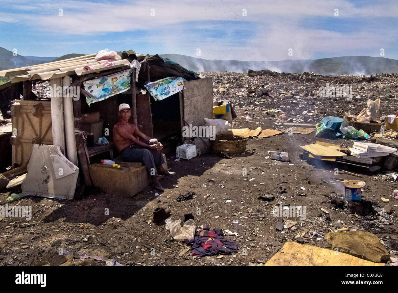 A Nicaraguan man, a garbage recollector, lives in a shack in the garbage dump La Chureca, Managua, Nicaragua. Stock Photo