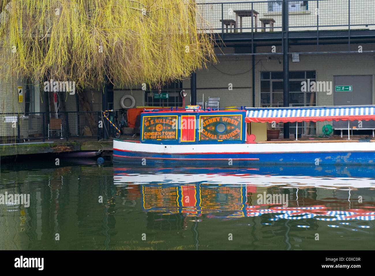 Camden Town or Lock or Market , London , willow tree by Jenny Wren Canal Cruises barge or boat with reflections in water Stock Photo