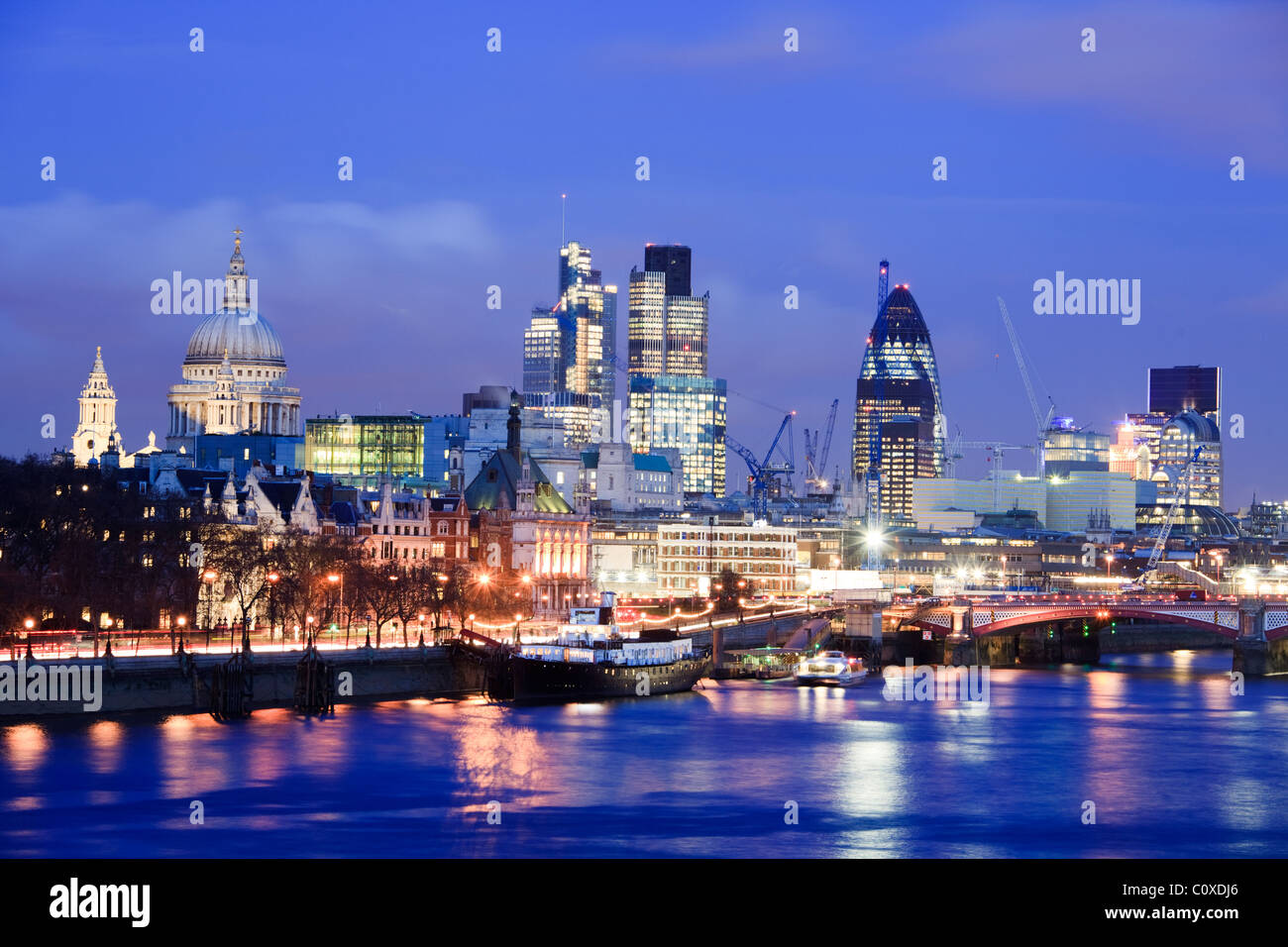 City Skyline viewed over river Thames at dusk; Dusk; London; UK Stock Photo
