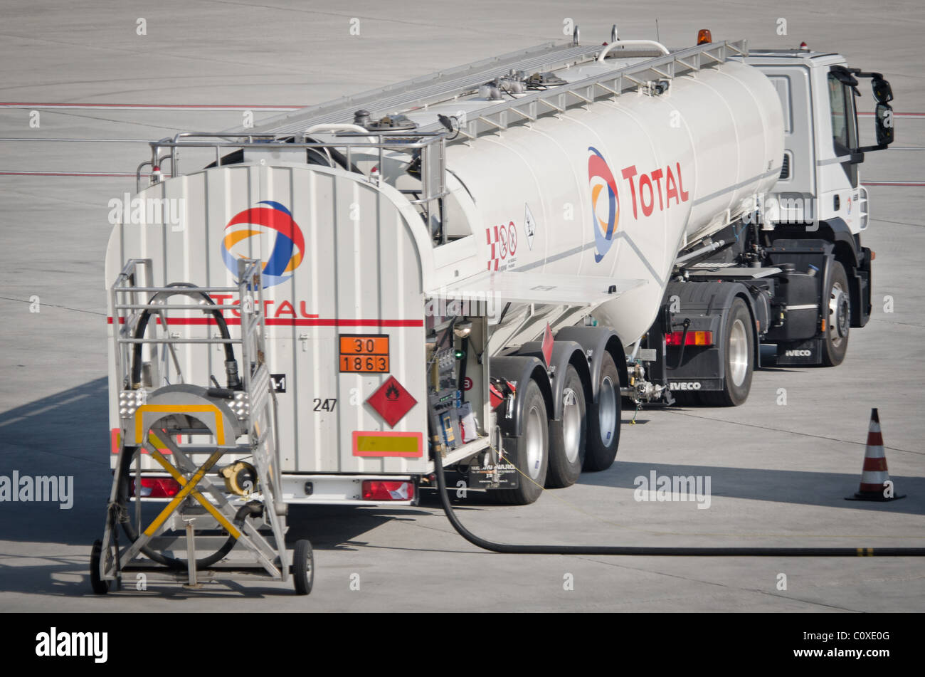 Fuel tanker at airport refueling aircraft Stock Photo