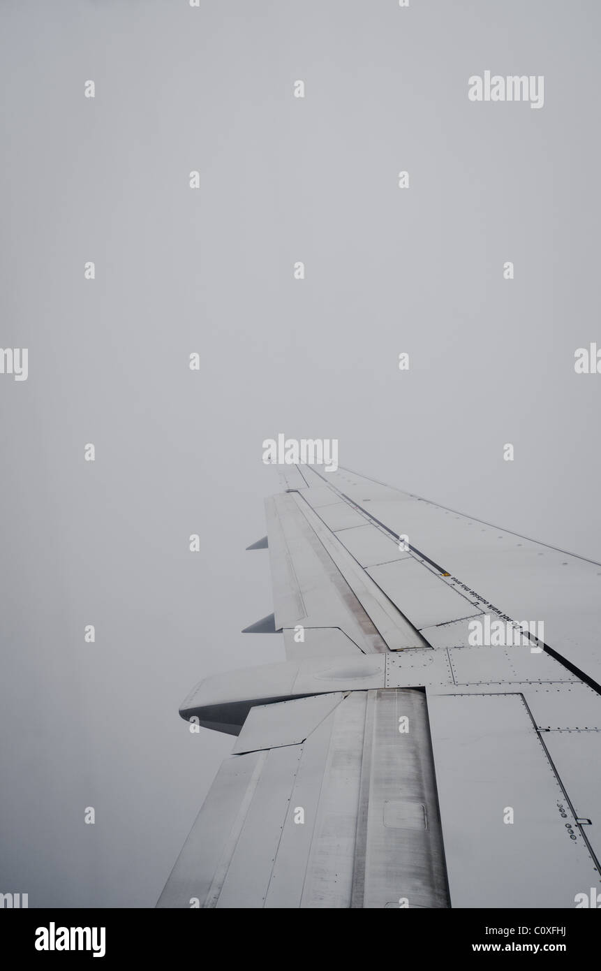 airplane wing in thick cloud Stock Photo Alamy