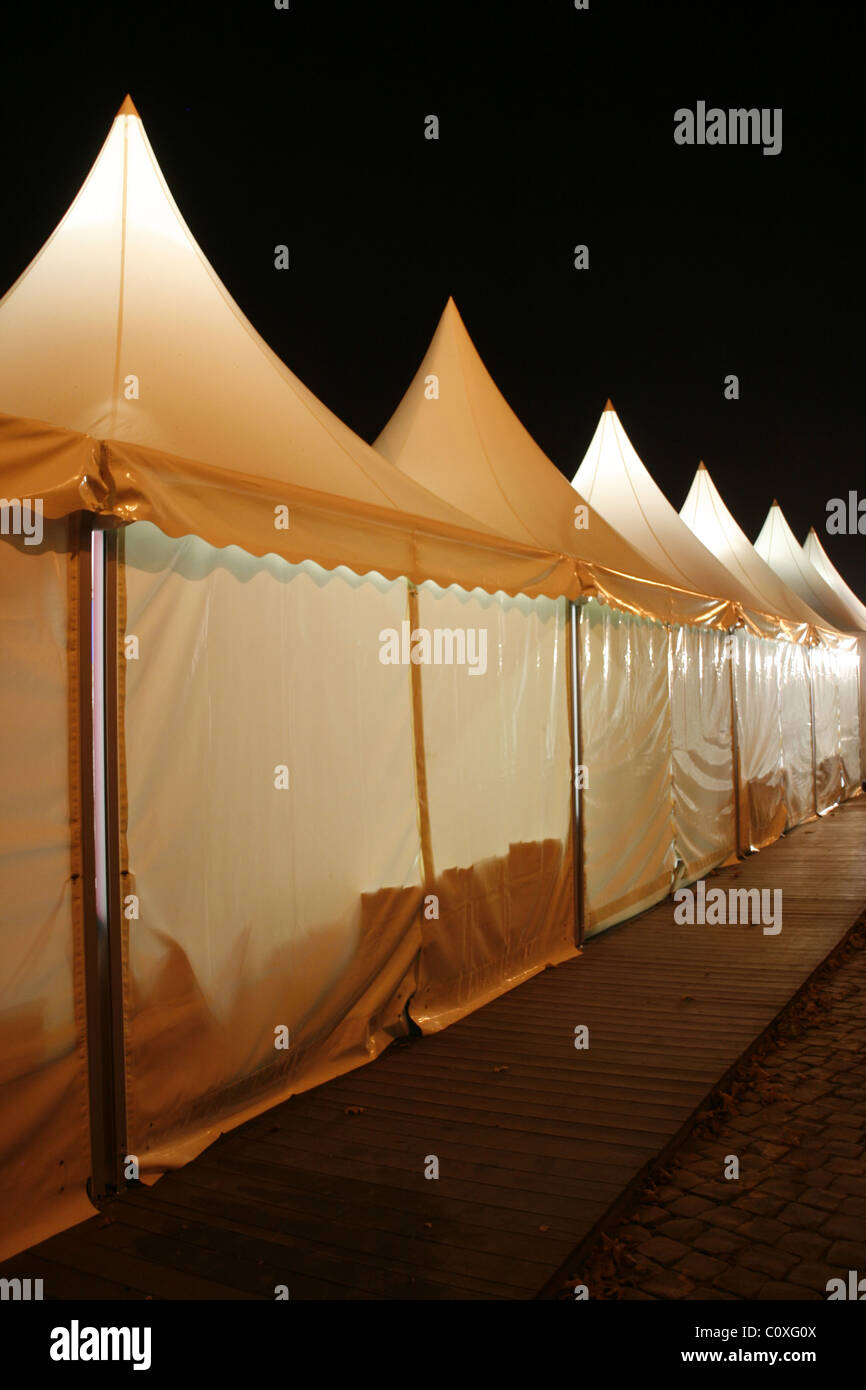row of market stalls tents at night at event Stock Photo Alamy