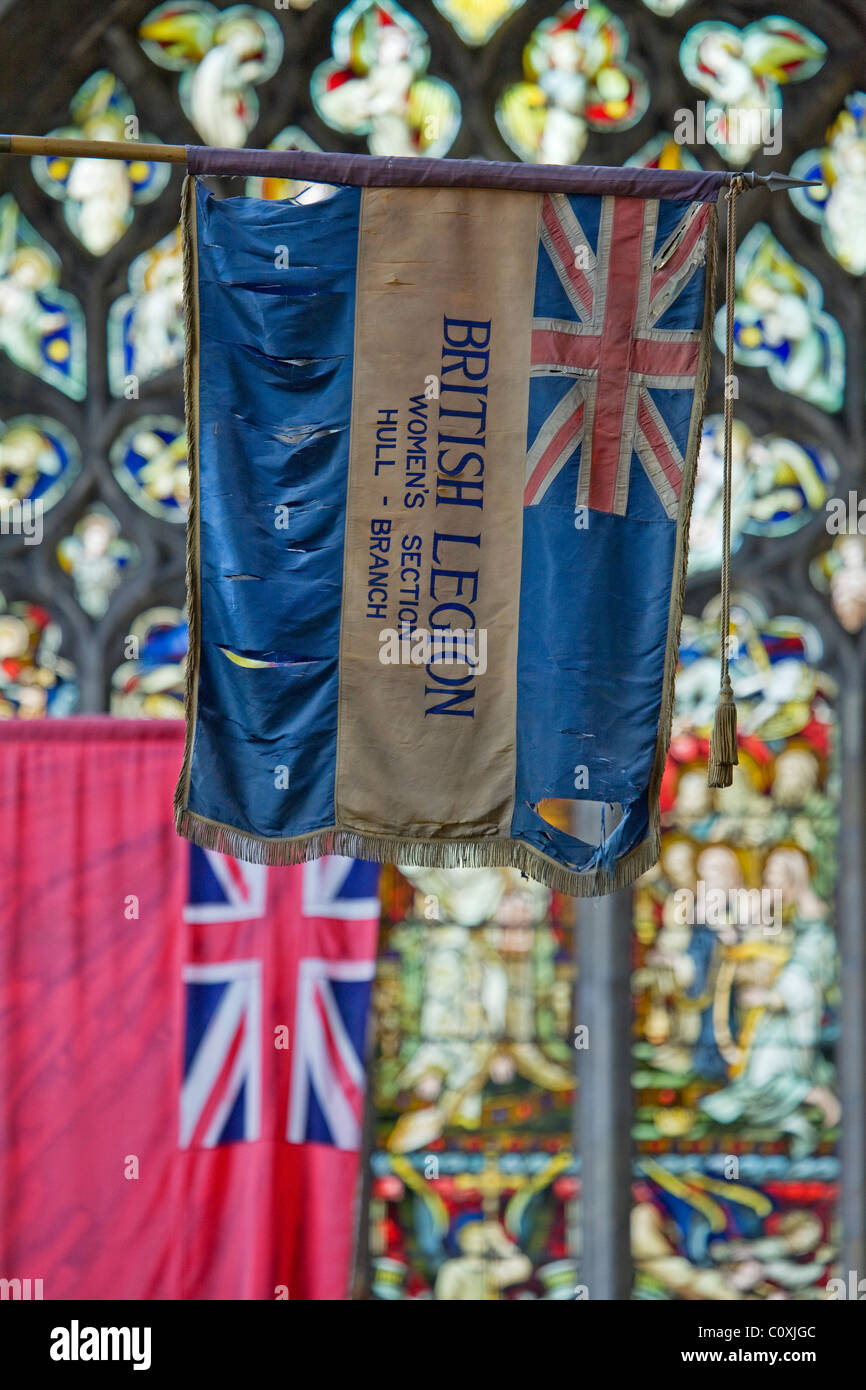 Regimental flags hang from the walls of the south choir aisle. Holy Trinity Church, Hull, East Yorkshire. Stock Photo