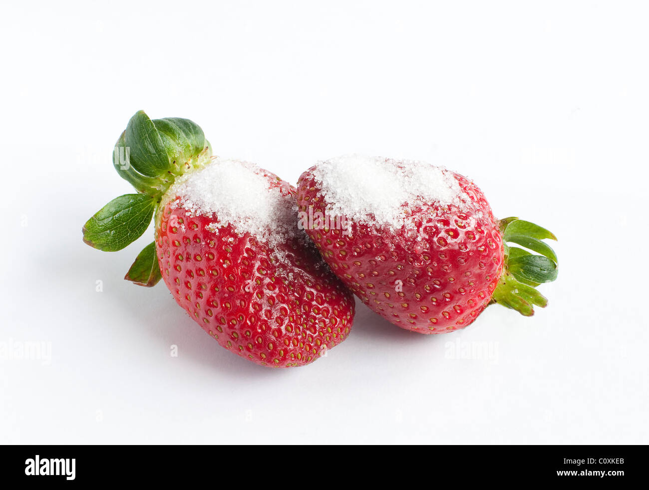 sugary strawberries on white background Stock Photo - Alamy