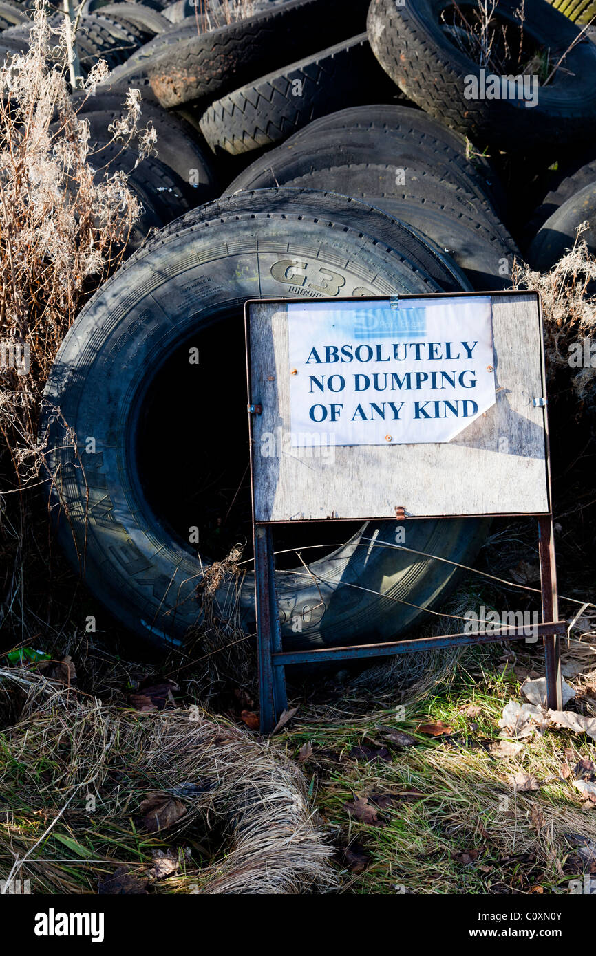 No Dumping Sign and Used Tyres Stock Photo