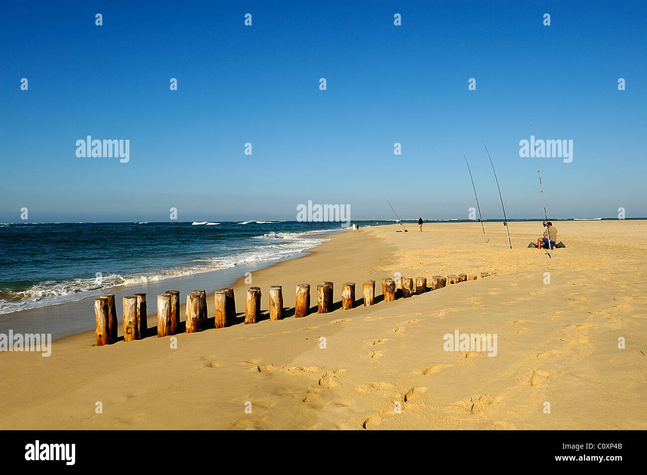 Fishing poles on a sandy beach along Atlantic Ocean, Cap Ferret, department of Gironde, France Stock Photo