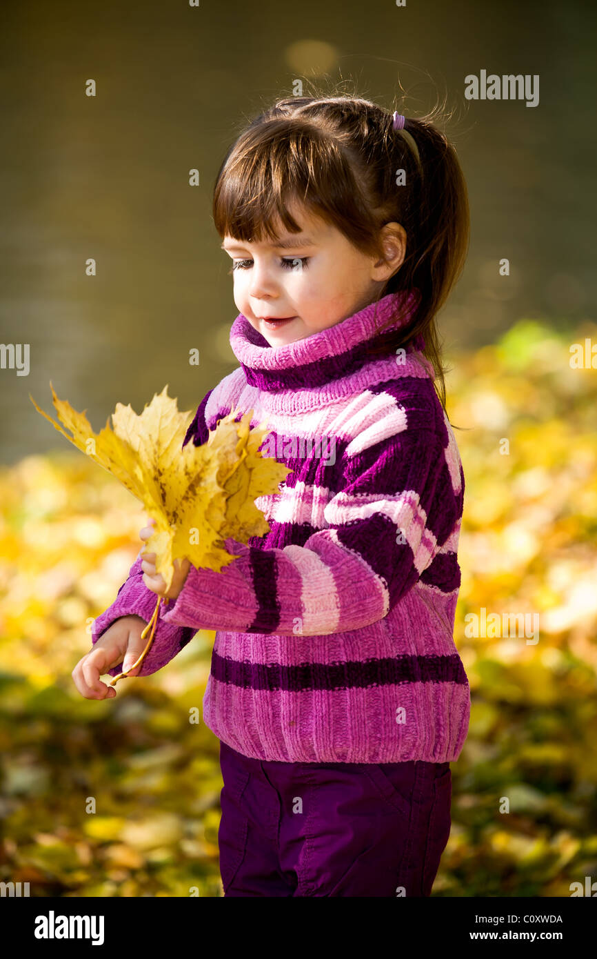 little girl in the autumn park Stock Photo - Alamy