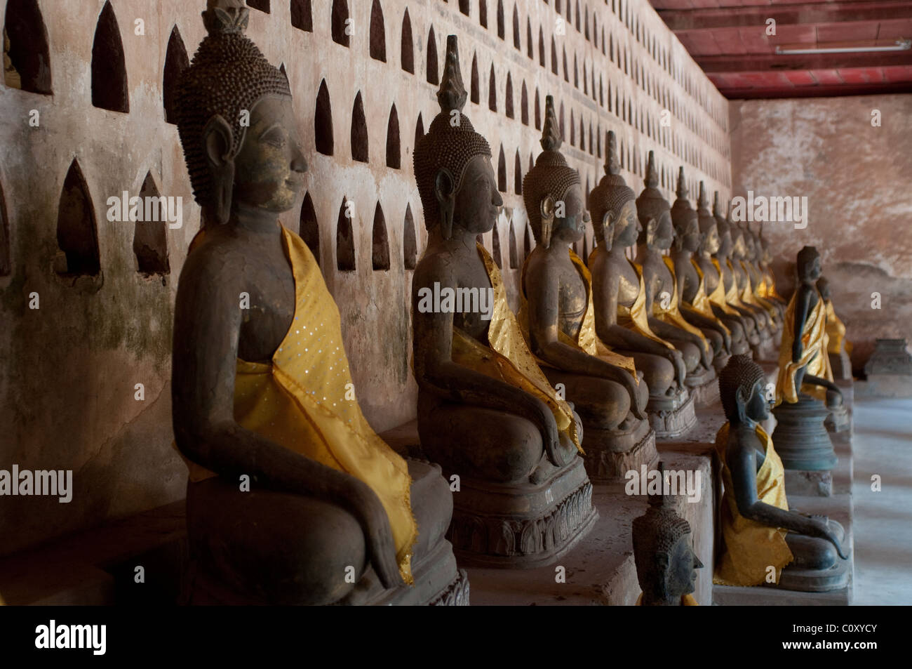 Row of sitting Buddhas, Wat Sisaket, Vientiane, Laos Stock Photo