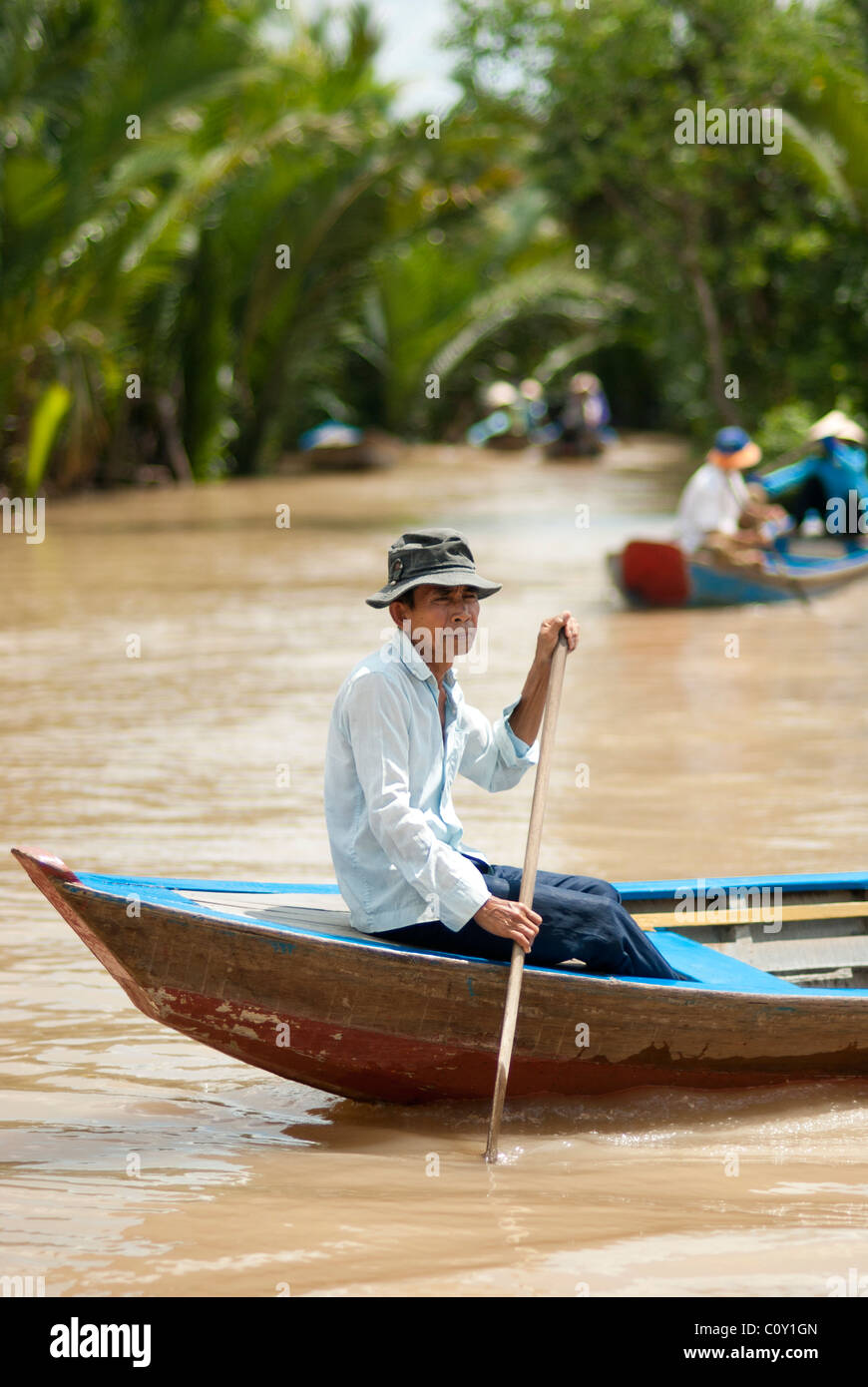 Mann on a boat in Mekong Delta Stock Photo - Alamy