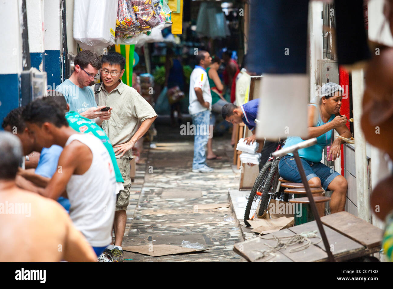 Tourists using a blackberry in Feira do Sao joaquim market in Salvador, Bahia, Brazil Stock Photo