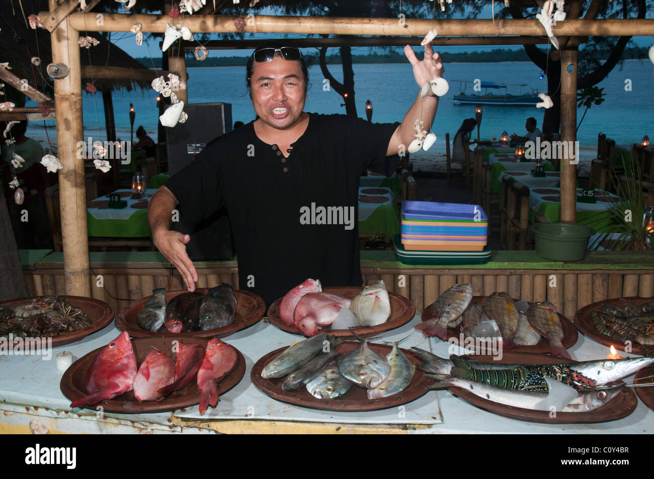 An extroverted restaurateur displays his wares at a seafood restaurant on the island of Gili Trawangan near Lombok Indonesia Stock Photo