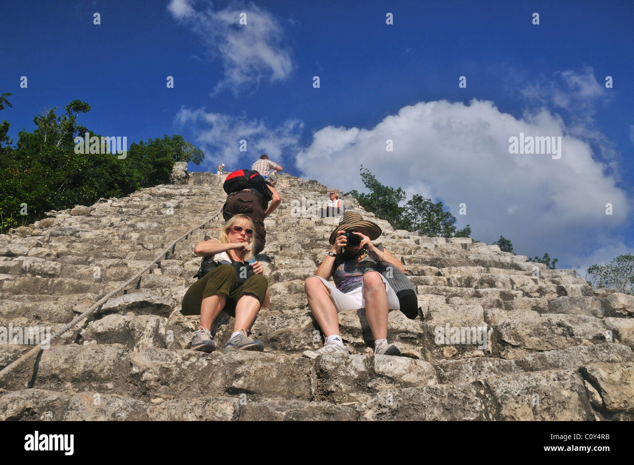 Tourists climbing the Nohoch Mul pyramid at the Mayan ruins of Coba Yucatan Mexico Stock Photo