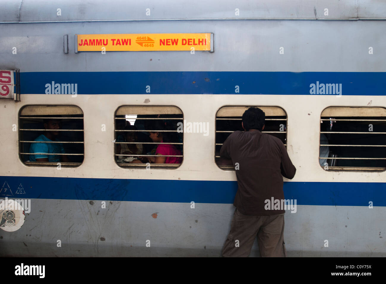 People waiting for a train departure in New Delhi train Station Stock Photo