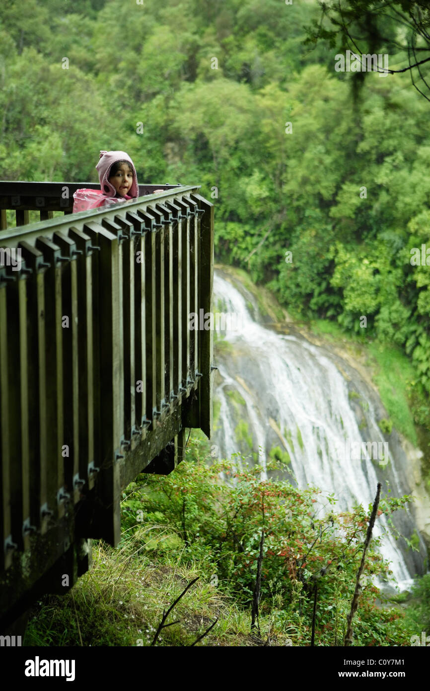 Girl stands on viewing platform looking over Tangoio Falls, near Napier, New Zealand Stock Photo