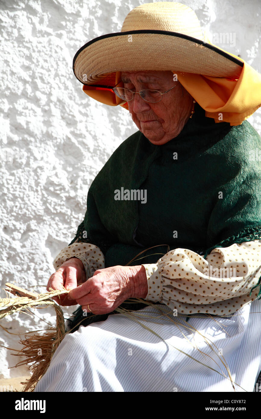 Elderly lady in traditional costume at a Handicraft Fair, Ibiza, Spain Stock Photo