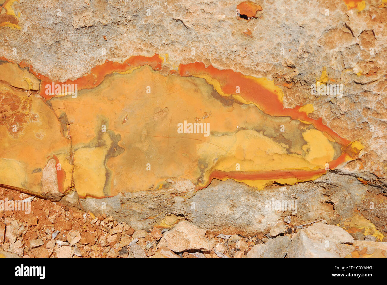 Ochre rock cracked by the sun to reveal its many colors, North West Cape, Western Australia. Stock Photo