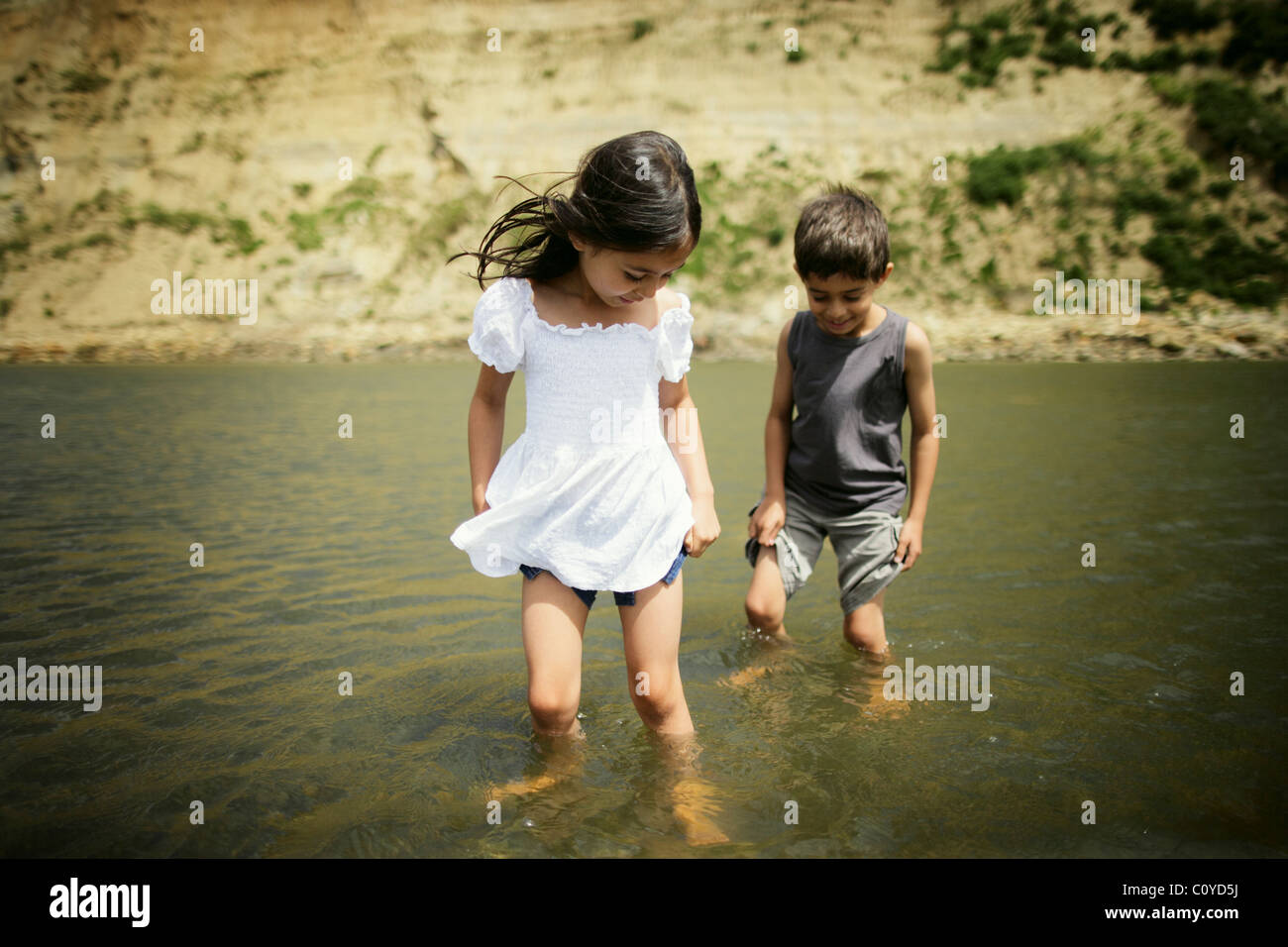 Boy and girl paddle in Manawatu river, New Zealand Stock Photo