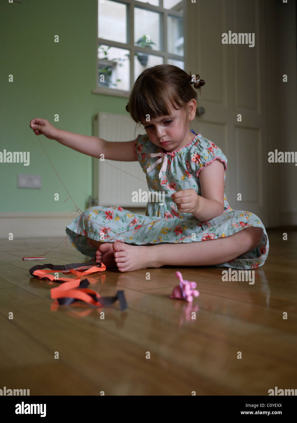 Child 3 years old playing with thread Craft indoors Stock Photo - Alamy