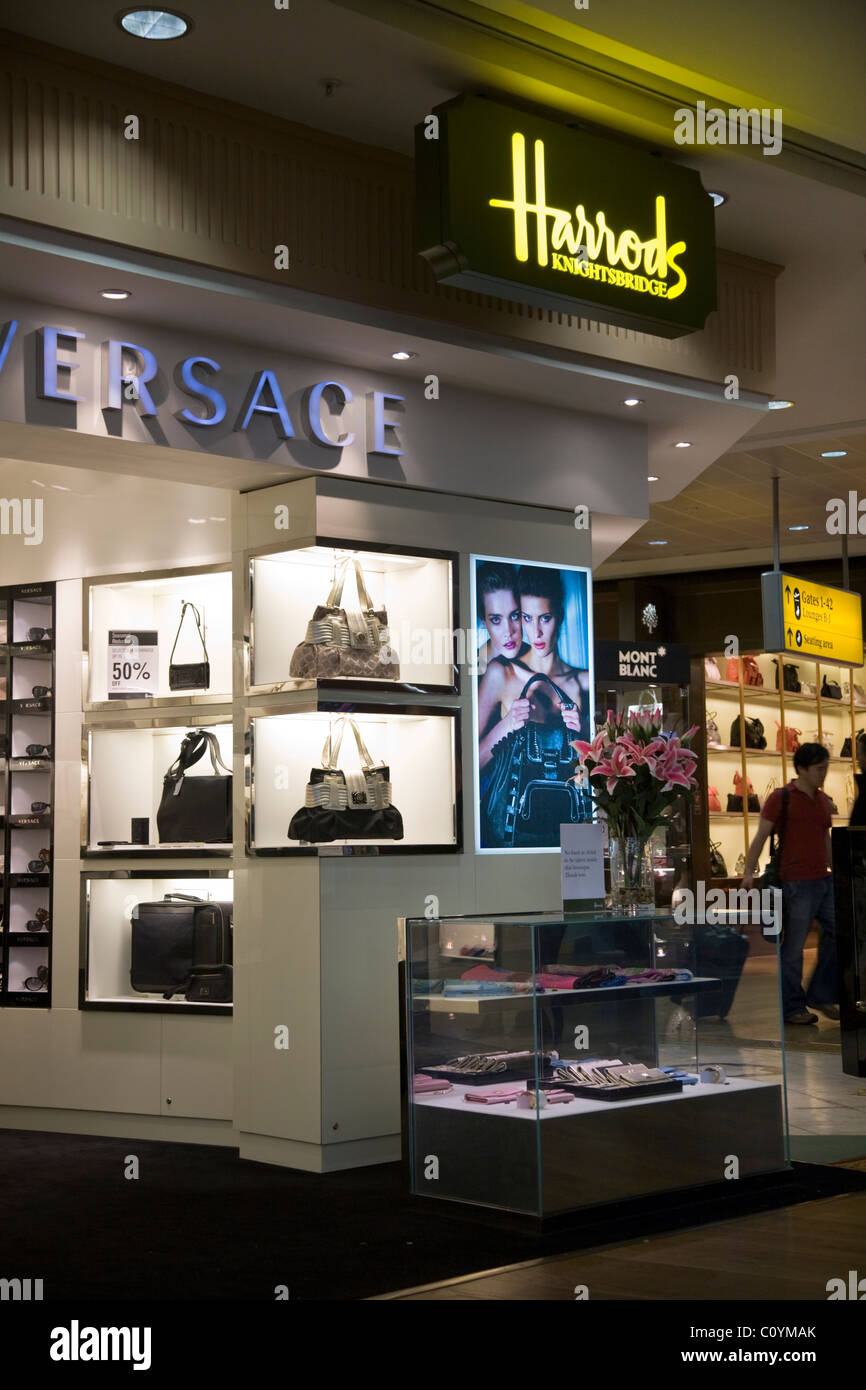 Versace bags for sale in the Harrods shop / outlet in the departure lounge  at London Heathrow airport Terminal 3 Stock Photo - Alamy