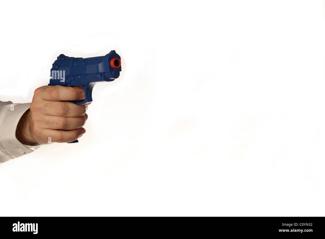 male hand holding a blue plastic toy gun Stock Photo