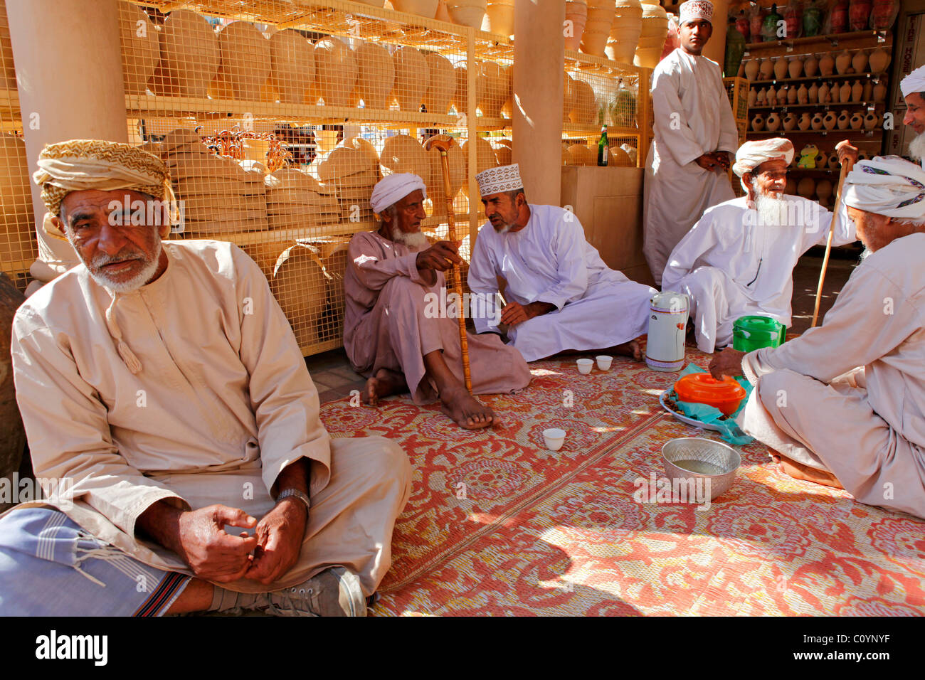 Omani men socialize over food in Nizwa, Oman. Stock Photo