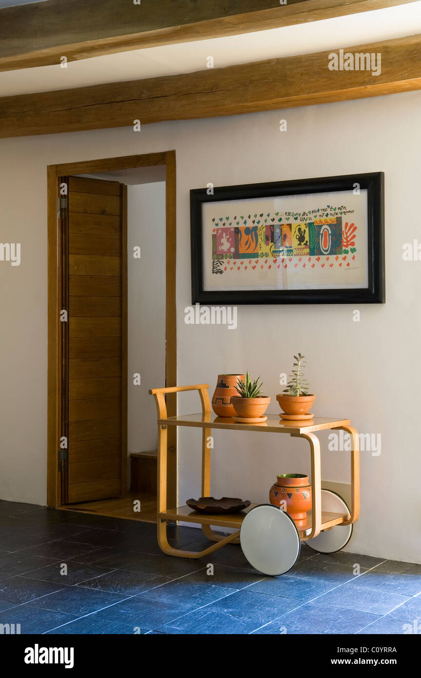 Potted cactus plants on an alvar aalto trolley in room with tiled floor Stock Photo