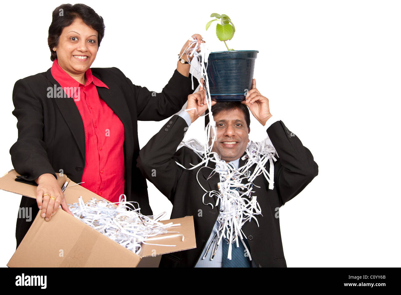 A couple engaged in a process of shredding paper to save the environment. Stock Photo