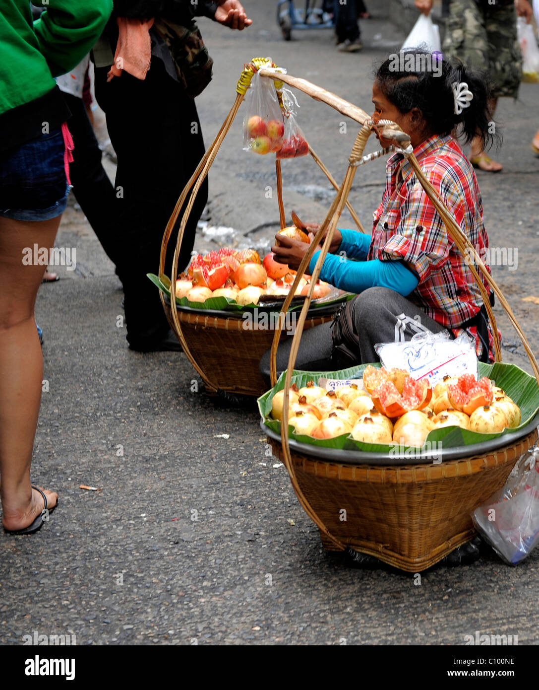 street hawker selling pomegranate fruit , yaowarat road , chinatown , bangkok, thailand Stock Photo