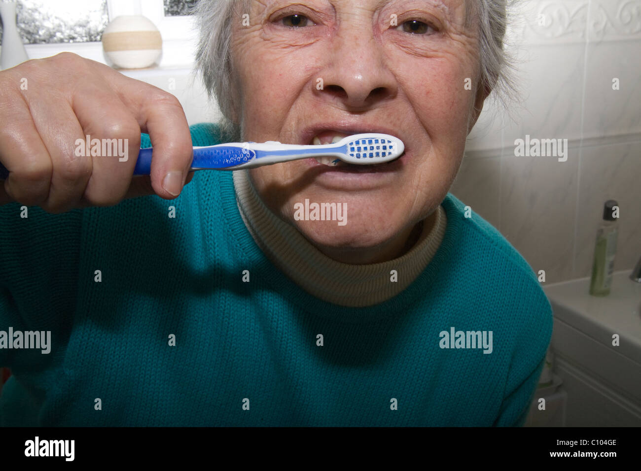 Close up elderly woman cleaning her teeth Stock Photo Alamy