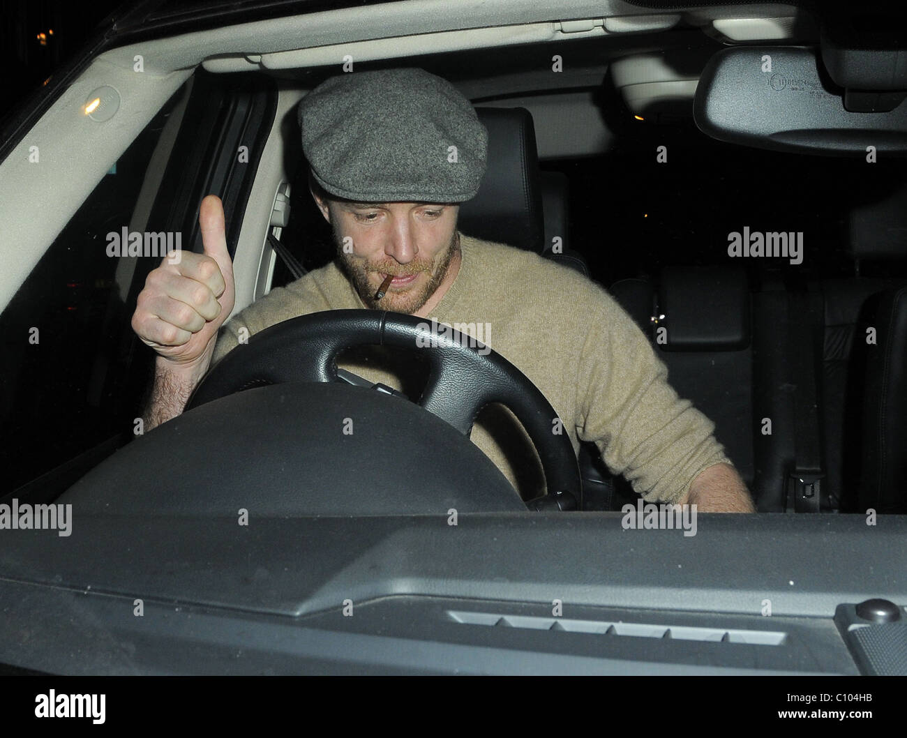Guy Ritchie leaves his Punch Bowl in Mayfair alone, smoking a roll up