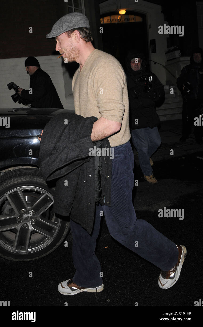 Guy Ritchie leaves his Punch Bowl in Mayfair alone, smoking a roll up