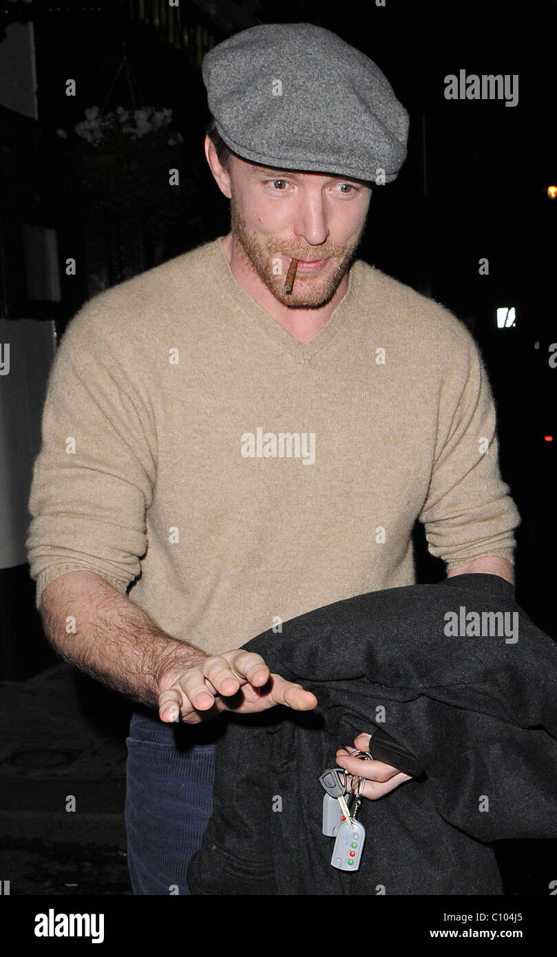 Guy Ritchie leaves his Punch Bowl in Mayfair alone, smoking a roll up