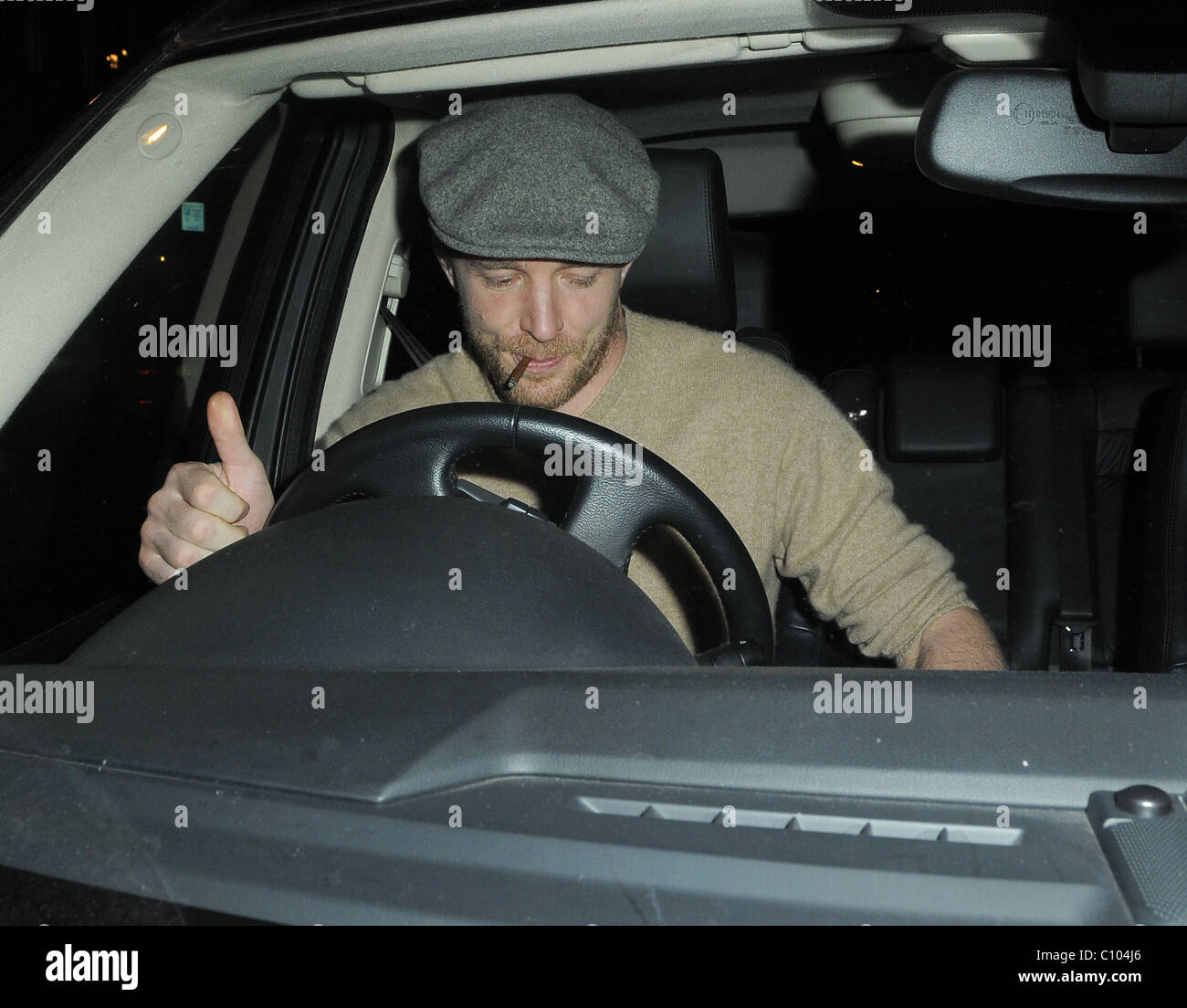 Guy Ritchie leaves his Punch Bowl in Mayfair alone, smoking a roll up