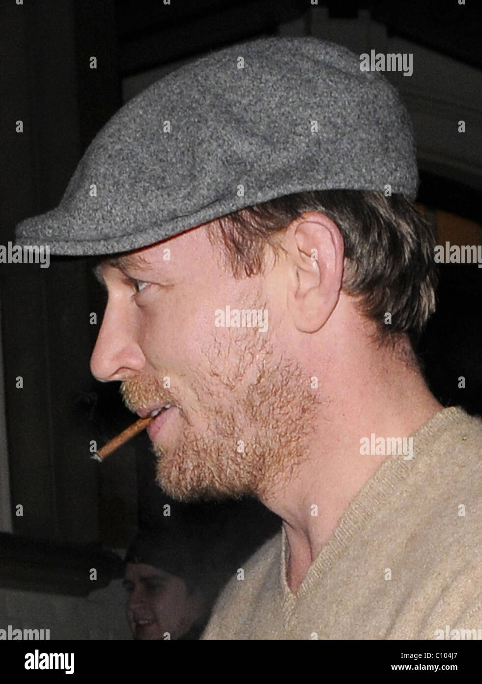 Guy Ritchie leaves his Punch Bowl in Mayfair alone, smoking a roll up