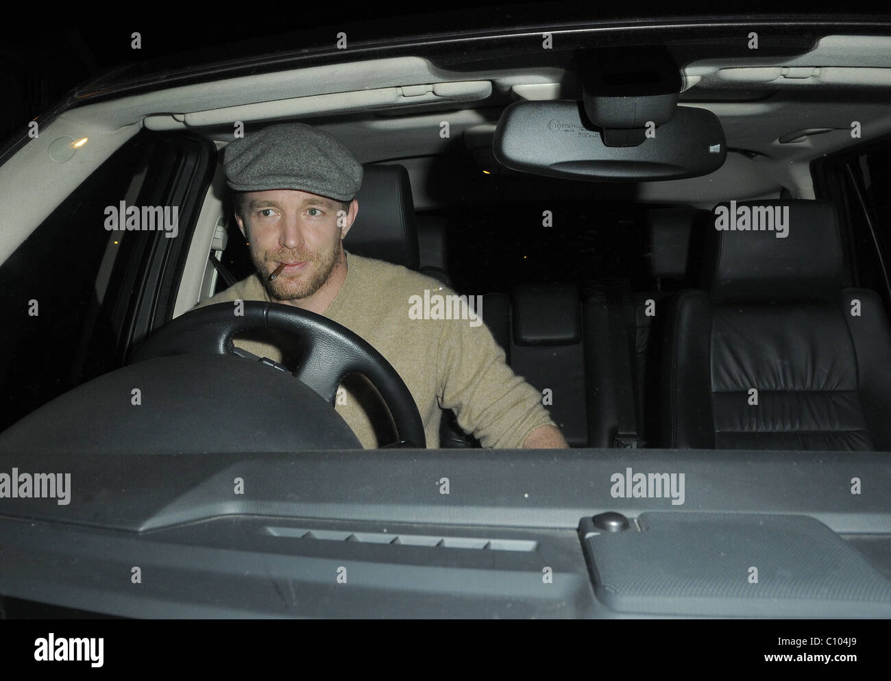 Guy Ritchie leaves his Punch Bowl in Mayfair alone, smoking a roll up