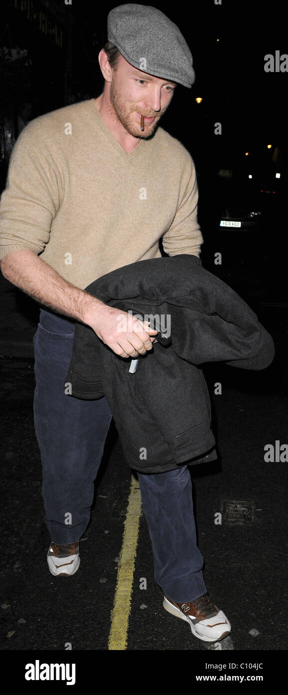 Guy Ritchie leaves his Punch Bowl in Mayfair alone, smoking a roll up