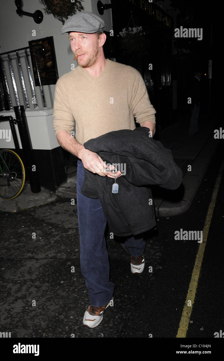 Guy Ritchie leaves his Punch Bowl in Mayfair alone, smoking a roll up