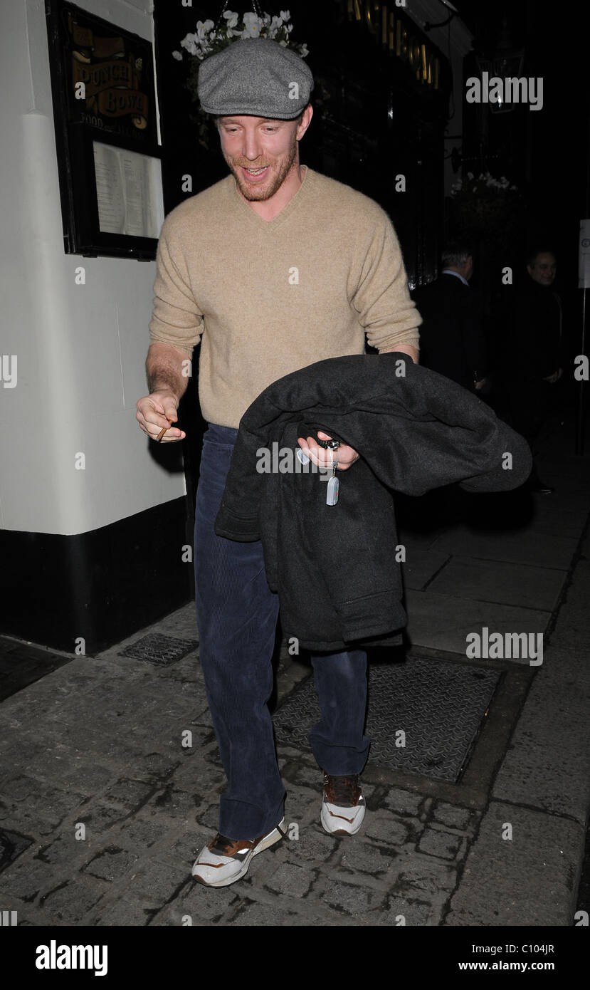 Guy Ritchie leaves his Punch Bowl in Mayfair alone, smoking a roll up