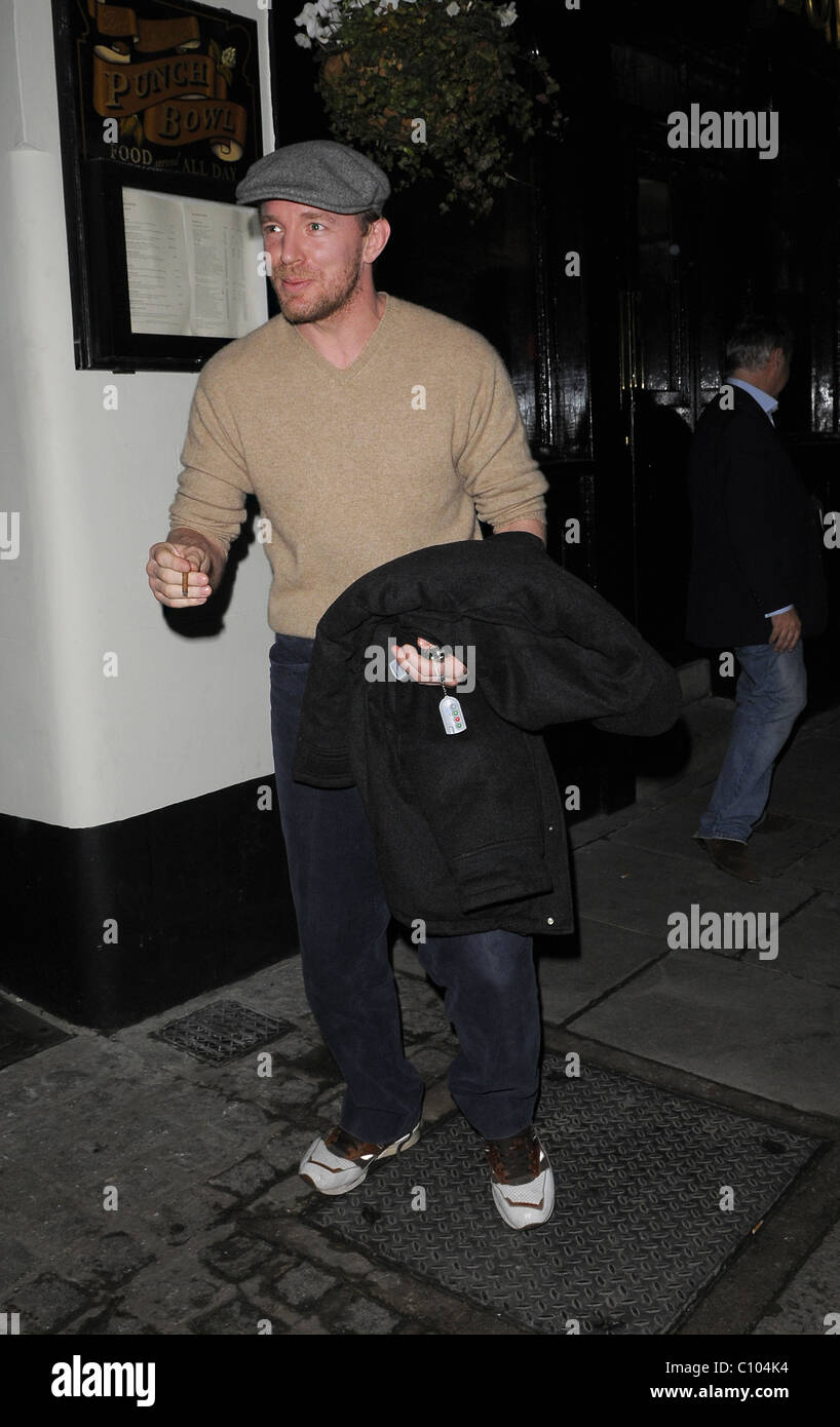 Guy Ritchie leaves his Punch Bowl in Mayfair alone, smoking a roll up