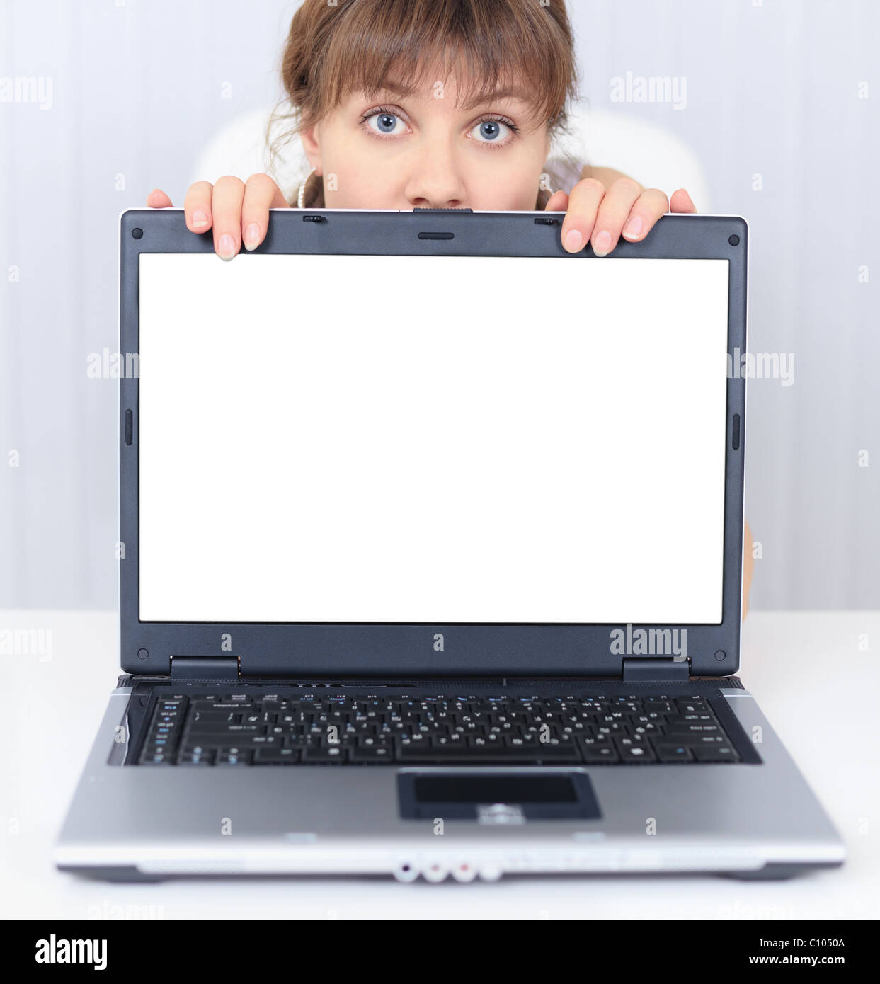 Woman shows us a blank computer screen Stock Photo